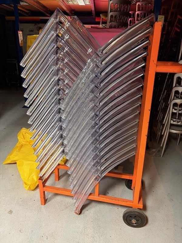 Stack of ghost chairs on a trolly / stillage