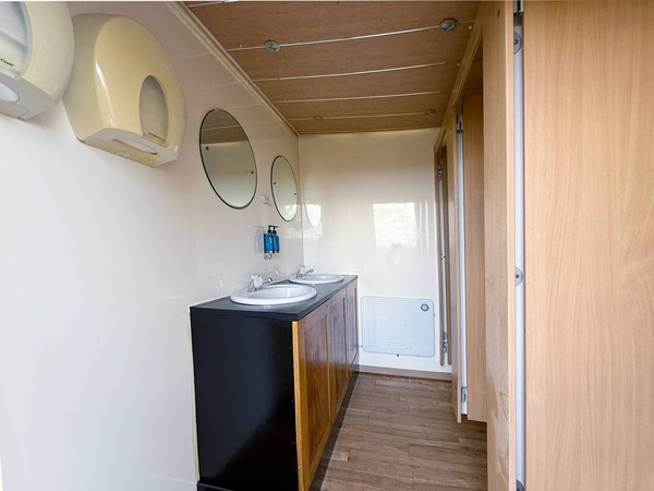 Clean white and wood 3 + 1 toilet trailer