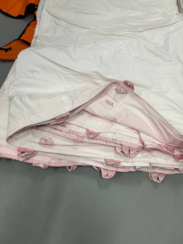 washed with a red tent and has been dyed a slight pink colour washed with a red tent and has been dyed a slight pink colour