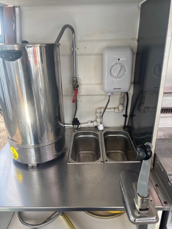 Catering van with water boiler and sink