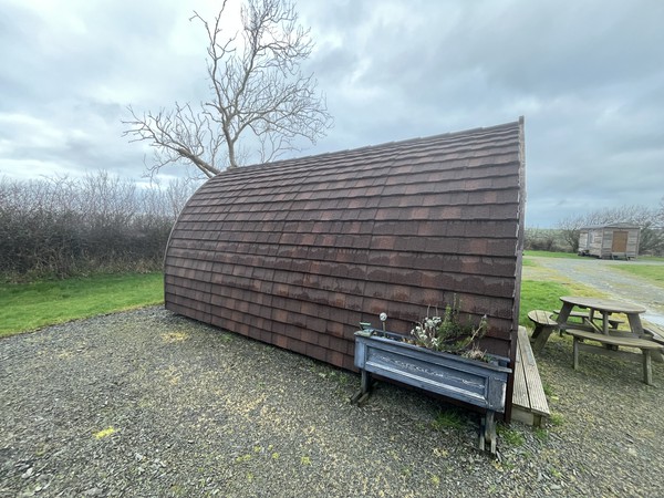 Camping pod with curved roof