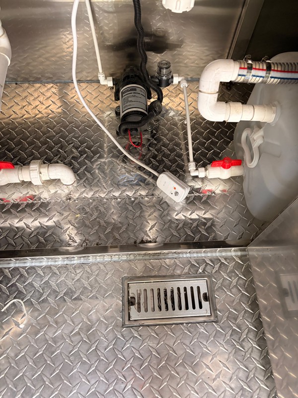 Catering trailer with water tank and pump