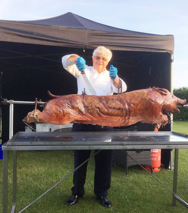 Chef carving hog