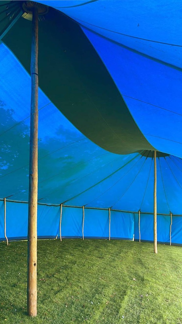 Canvas big top with round wood poles