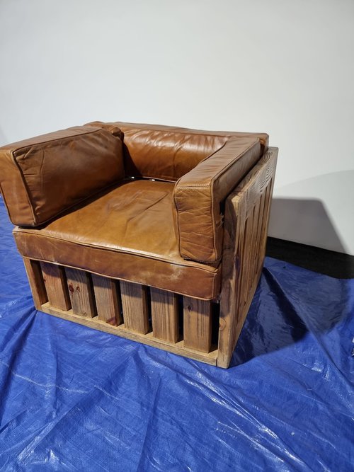 Reclaimed wood pallet chairs with leather cushions