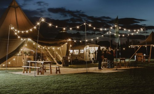 Festoon lighting held up with shepherd's crooks