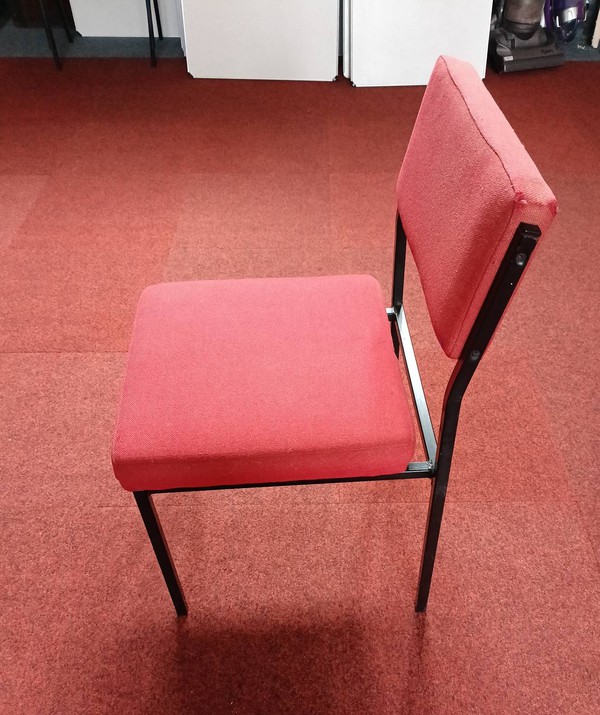Red upholstered chairs with metal frame.