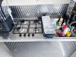 Double stainless steel sink and four burner stove