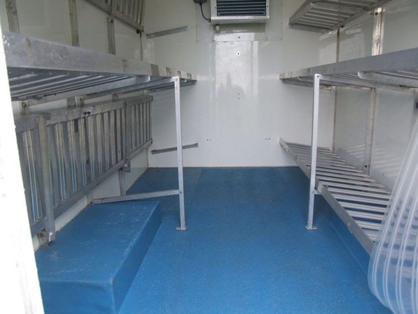 Refrigerated trailer with folding shelves