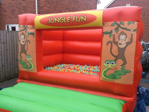 Jungle bouncy castle with ball pool balls Jungle bouncy castle with ball pool balls