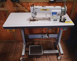 Sewing machine on table for sale