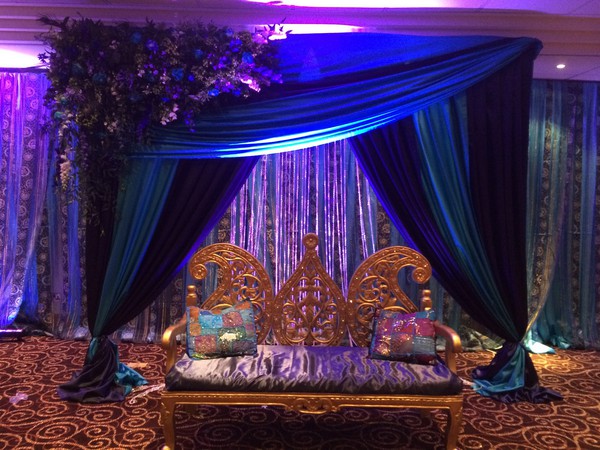 Blue and Teal stage backdrop with Gold wedding sofa