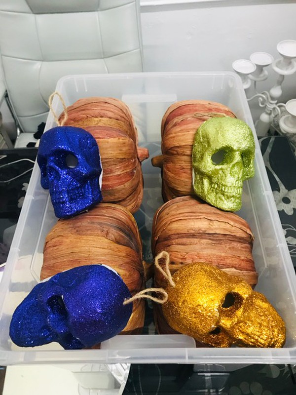 box of Halloween rustic pumpkins and coloured skeletons