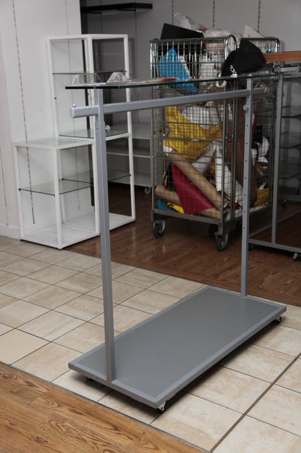 Clothes rail with glass shelf above