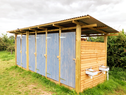 Six bay wooden shower block with corigated Steel roof
