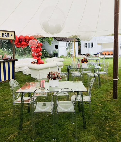 Glass and Chrome Leg Tables in marquee setting Glass and Chrome Leg Tables in marquee setting