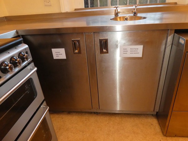 Stainless steel prep table with cupboards and hand wash sink