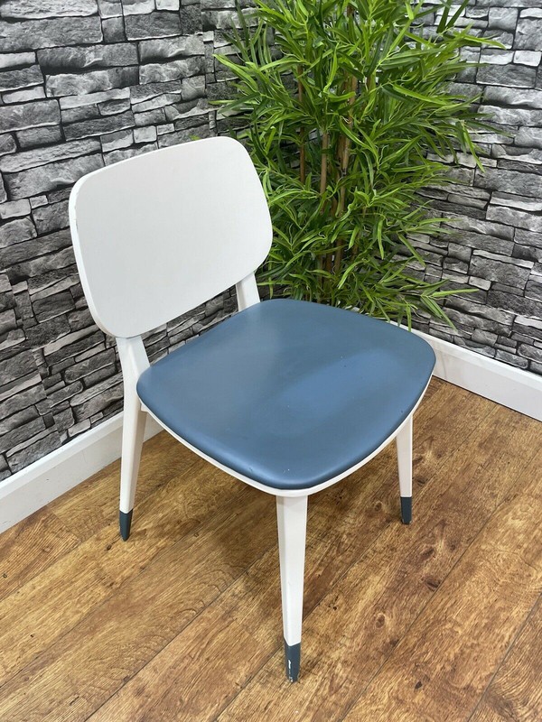 White chairs with blue seat pads