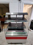 Heated food display with curved glass