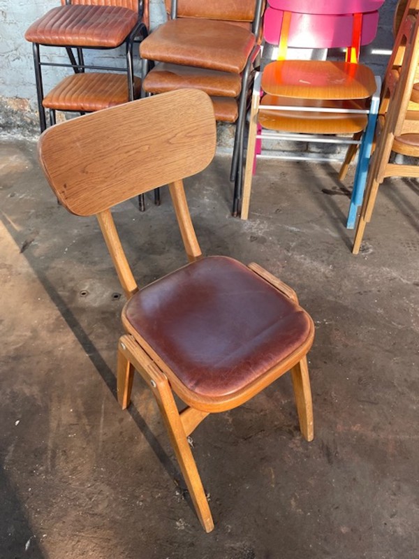 Used stackable wooden chairs with leather seat pads