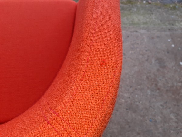 Orange fabric reception tub style chairs.