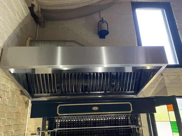 Rotisserie with cooker hood