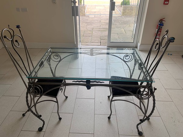 Glass table with wrought iron legs