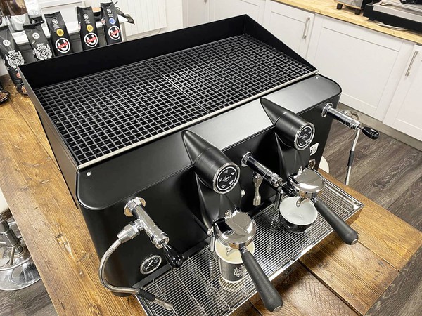 Compact black espresso machine