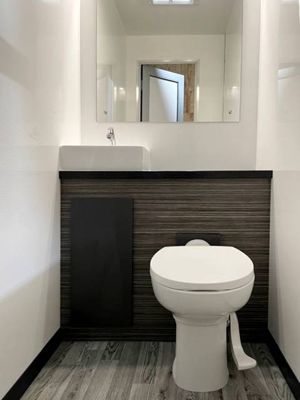 Toilet cubicle white with wood trim