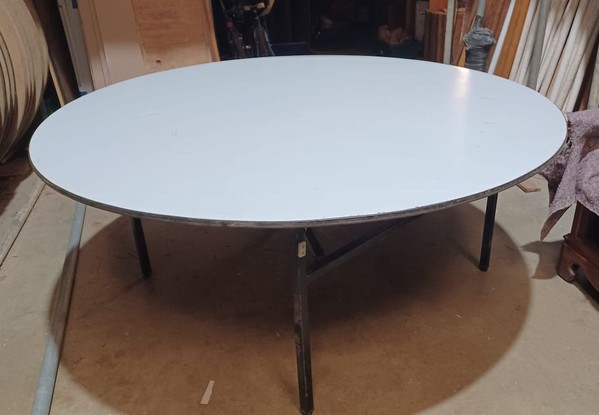 6ft Diameter round wooden table with soft PVC covering.