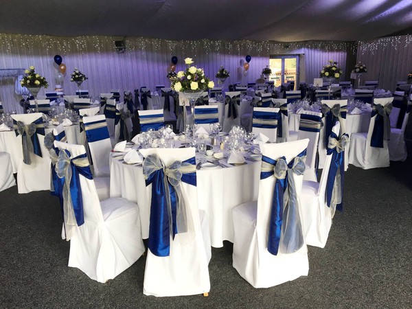 White chair cover and blue bows