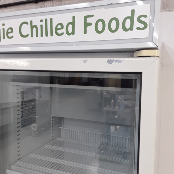 Chilled food fridge with illuminated sign