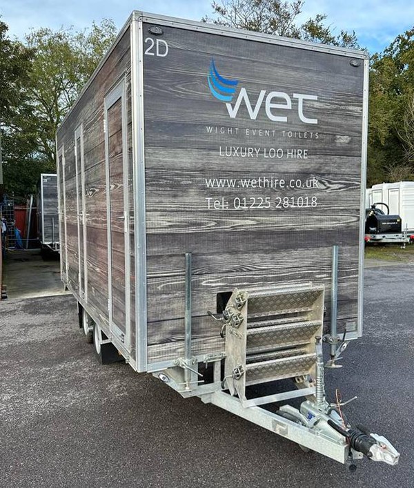 Toilet trailer wrapped in wood vinyl rap