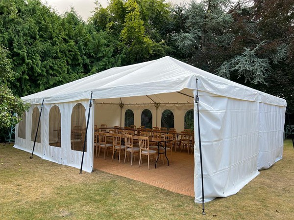 Marquee with matting and tables and chairs