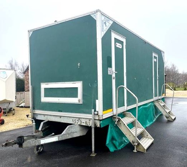 Toilet trailer with steps and  a skirt