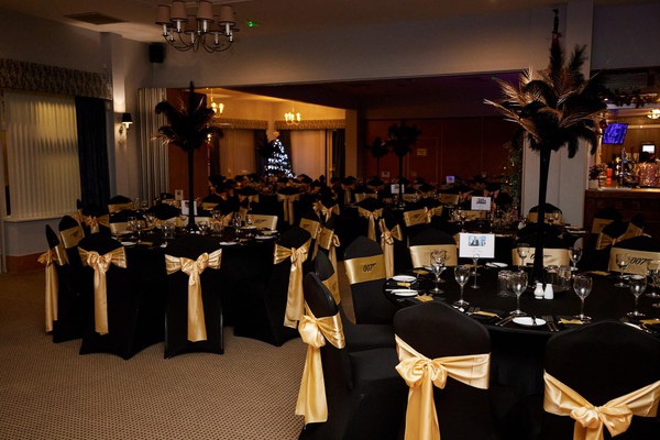 Black chair covers with gold bows