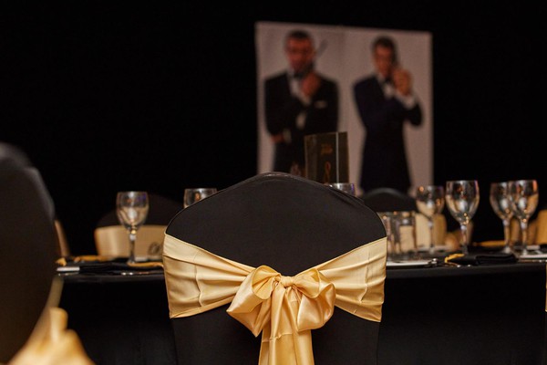 Gold bows with black chair covers