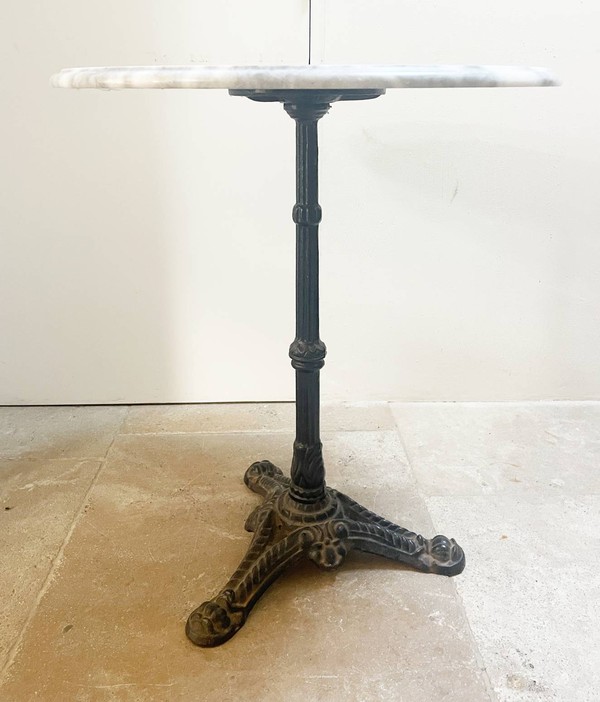 Marble table with heavy cast iron base