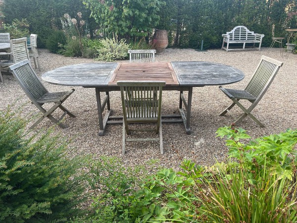 Oval teak dining table and chairs