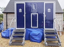 Blue toilet trailer with matching skirt