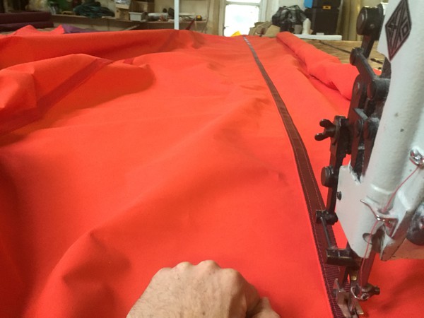 Red canvas being sewed