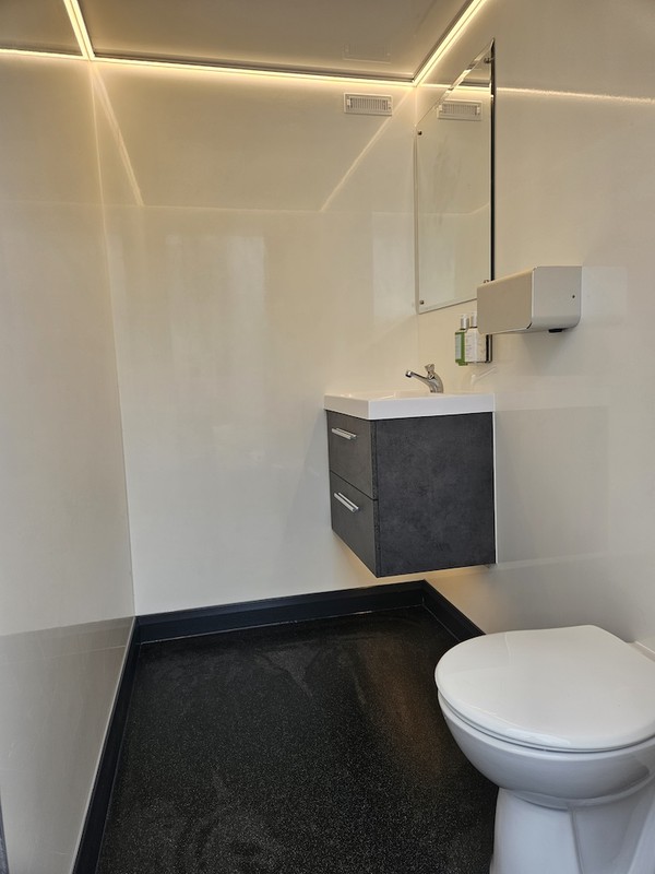 Clean white and grey toilet trailer