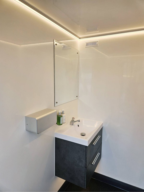 Clean white and grey toilet trailer