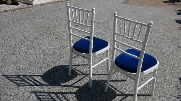 Secondhand White Wooden Chiavari Chairs and Blue Velvet Seat Pads For Sale