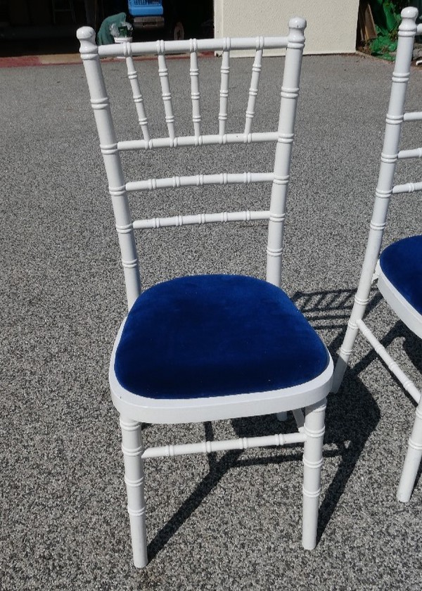 Secondhand White Wooden Chiavari Chairs and Blue Velvet Seat Pads For Sale