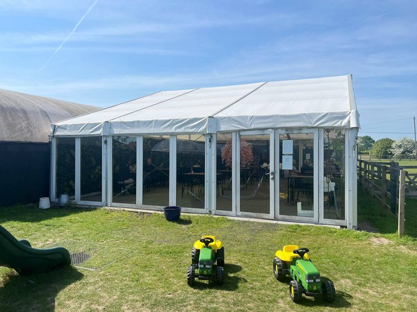12m wide framed marquee with full height windows
