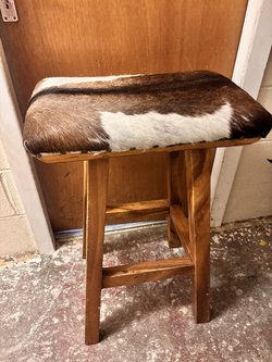 brown and white cow hide stool
