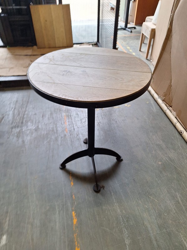 Wooden round table with metal trim