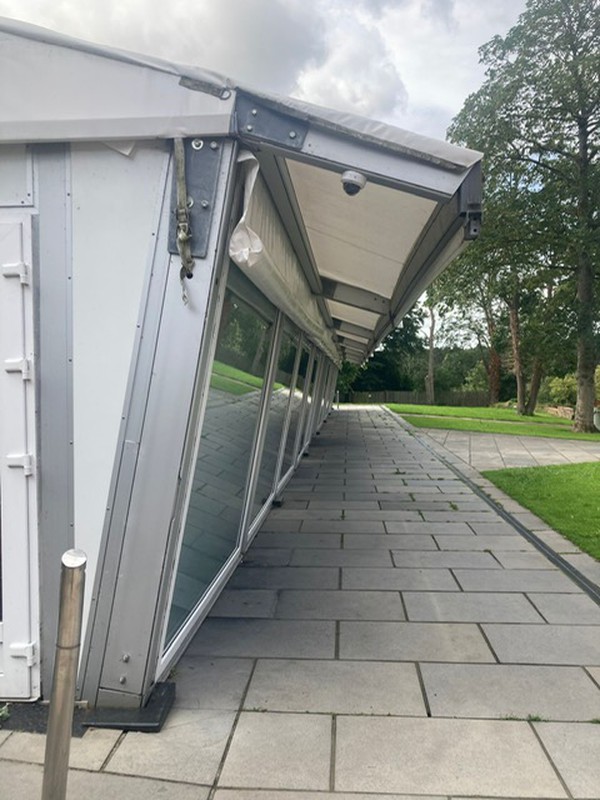 Glass panoramic windows and roof overhang