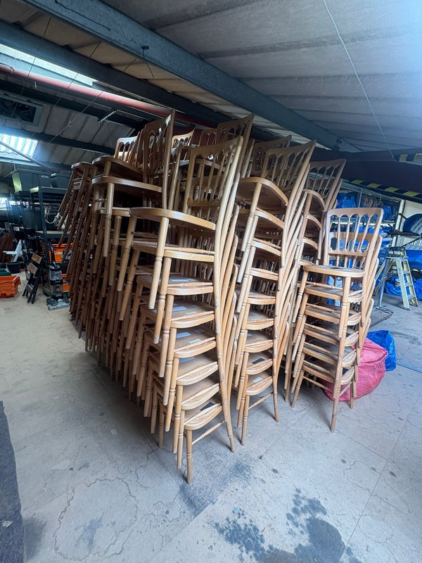 Stacking Natural Cheltenham Chairs with Blue Seat Pads.